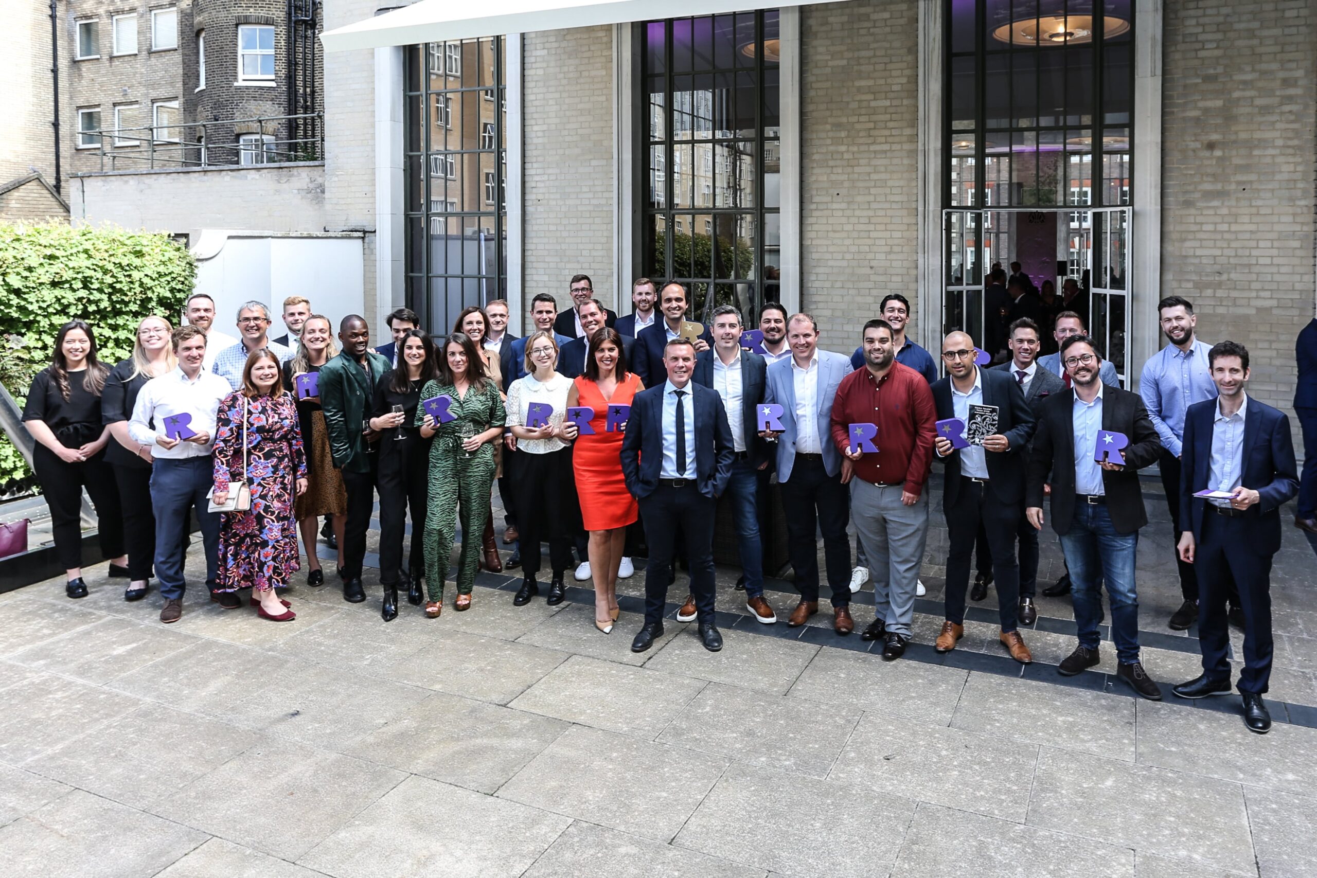 TIARA Talent Tech Award winners stand outside the RIBA  building holding up their trophies. Pixid's Daniel  Kieve (Marketing manager) and Julian Mariotti (Business Development Manager) are at the front right of the photo